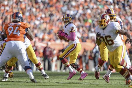 Washington Redskins quarterback Robert Griffin III (10) drops back to pass in the second quarter against the Denver Broncos at Sports Authority Field at Mile High. Mandatory Credit: Ron Chenoy-USA TODAY Sports