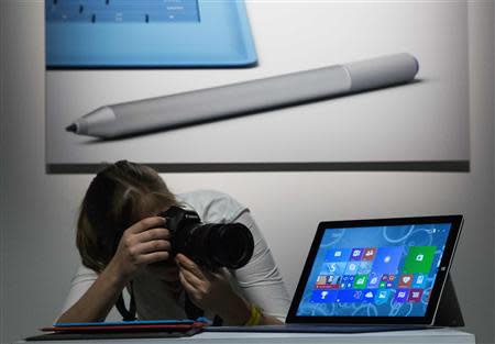 An attendee photographs the new Microsoft Surface Pro 3, during the event in New York May 20, 2014. REUTERS/Brendan McDermid