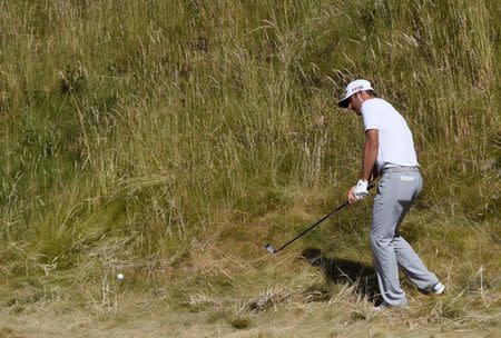 Jun 21, 2015; University Place, WA, USA; Dustin Johnson hits from the rough on the 6th hole in the final round of the 2015 U.S. Open golf tournament at Chambers Bay. Kyle Terada-USA TODAY Sports