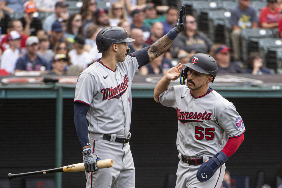 Minnesota Twins' Mark Contreras (55) celebrates with Carlos Correa after scoring on a single by Luis Arraez during the ninth inning of a baseball game against the Cleveland Guardians in Cleveland, Sunday, Sept. 18, 2022. (AP Photo/Phil Long)