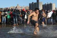 <p>A participant rushes in the water during a polar bear plunge at the beach in Coney Island, Brooklyn on Jan. 1, 2018. New Yorkers took part in new year’s day swim with temperature standing at -7 degrees Celsius. (Photo: Atilgan Ozdil/Anadolu Agency/Getty Images) </p>