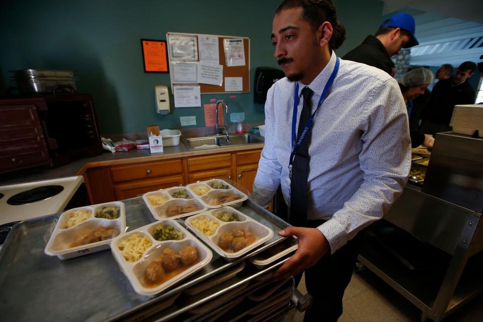 Gerami Pacheco, program manager, wheels out meals to be delivered to seniors as part of the Coastline Elderly's Meals on Wheels program in New Bedford.