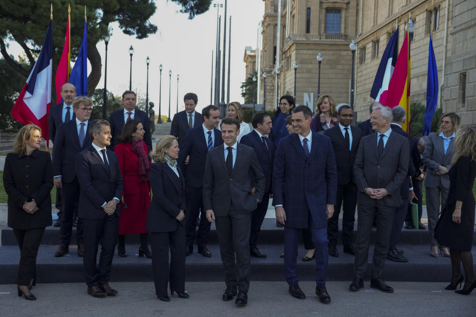 French President Emmanuel Macron and Spanish counterpart Pedro Sánchez, centre, after a family picture with members of the France and Spanish delegations in Barcelona, Spain, on Thursday, Jan. 19, 2023. A summit between the Spanish and French governments, led by their executive leaders, prime minister Pedro Sánchez and president Emmanuel Macron, is held in the capital of Catalonia to strengthen relations between the European neighbors by signing a friendship treaty. (AP Photo/Emilio Morenatti)