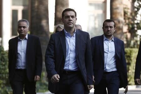 Alexis Tsipras (C), leader of Greece's far-left Syriza party, leaves the Presidential palace in Athens November 3, 2014. REUTERS/Yorgos Karahalis