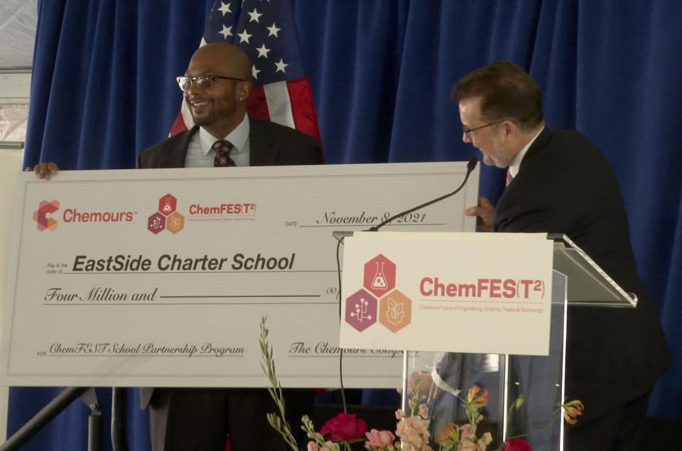 Aaron Bass, CEO of Eastside Charter School (left), is presented with a $4 million dollar by Mark Newman, President and CEO of Chemours (right).