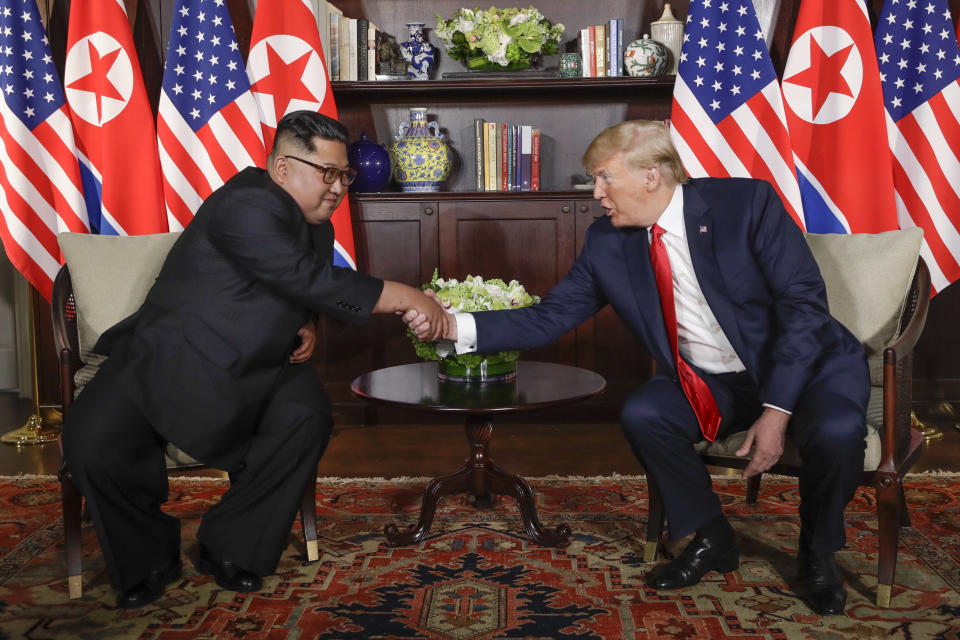 FILE - In this June 12, 2018, file photo, North Korea leader Kim Jong Un, left, and U.S. President Donald Trump shake hands during their first meeting at the Capella resort on Sentosa Island in Singapore. Vietnam's selection as the venue for the second summit meeting of them is largely a matter of convenience and security, but not without bigger stakes. (AP Photo/Evan Vucci, File)