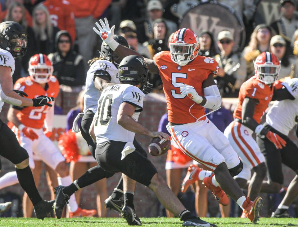 Clemson defensive end K.J. Henry (5)  pressures Wake Forest quarterback Sam Hartman (10) during the second quarter at Memorial Stadium in Clemson, South Carolina Saturday, November 20, 2021.