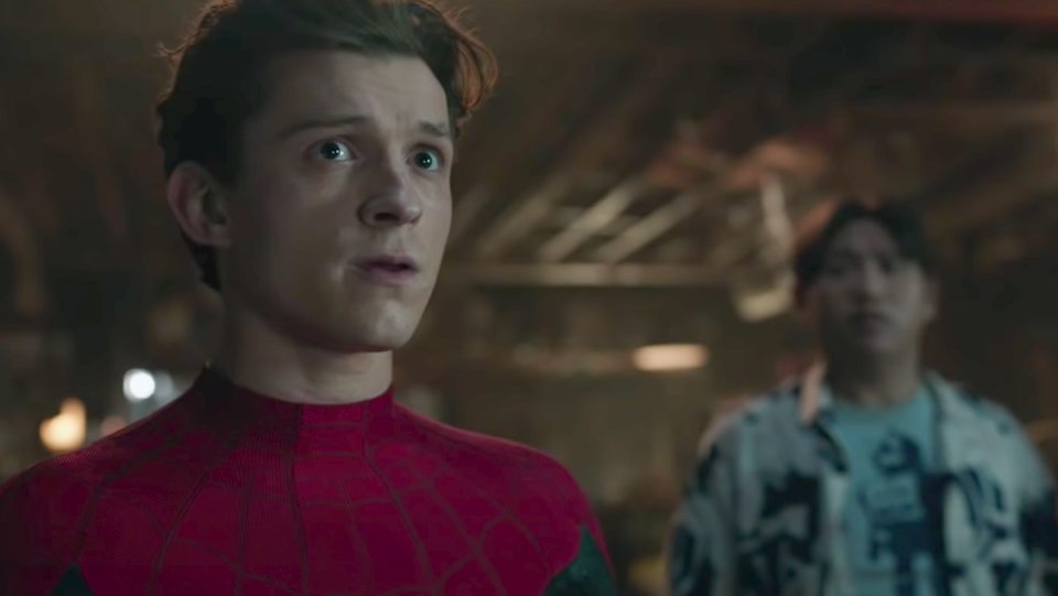 Tom Holland's Peter parker looks worried with Ned in the background in No Way Home in the Spider-Man therapy article.