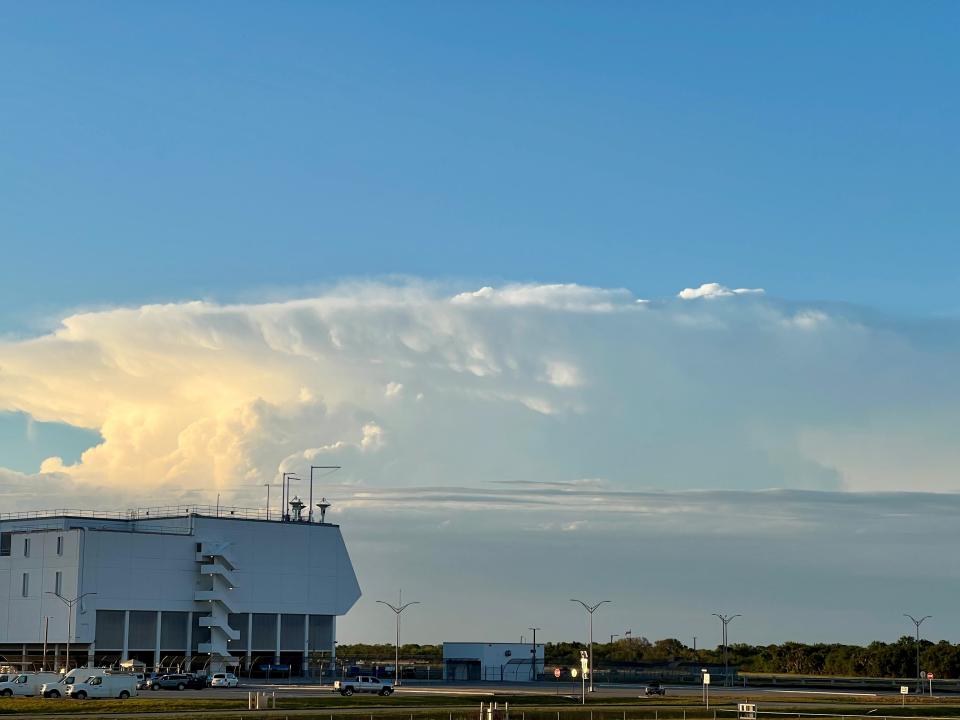 A large storm cloud passes north of NASA's Kennedy Space Center press site amid launch delays Saturday night.