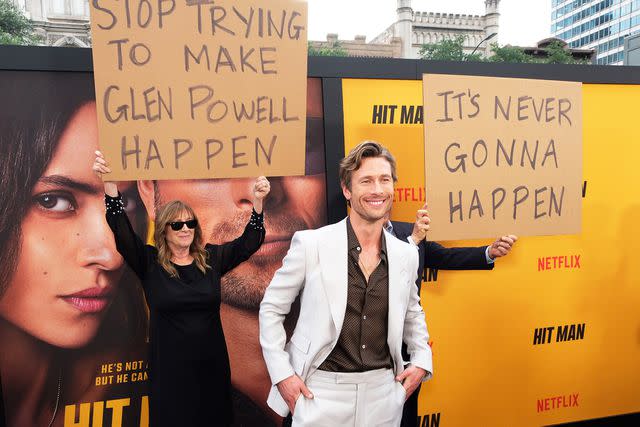 <p>Hubert Vestil/Getty</p> Glen Powell and his parents at the 'Hit Man' premiere