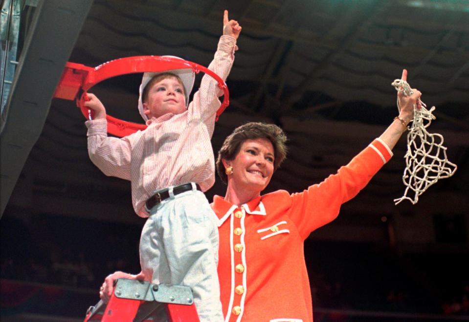 FILE - In this March 31, 1996, file photo, Tennessee coach Pat Summitt and son Tyler, take down the net after Tennessee defeated Georgia 83-65 in the title game at the NCAA women's basketball Final Four at Charlotte Coliseum in Charlotte, N.C. Summitt, the winningest coach in Division I college basketball history who uplifted the women's game from obscurity to national prominence during her career at Tennessee, died Tuesday morning, June 28, 2016. She was 64. (AP Photo/Pat Sullivan, File) ORG XMIT: NY203