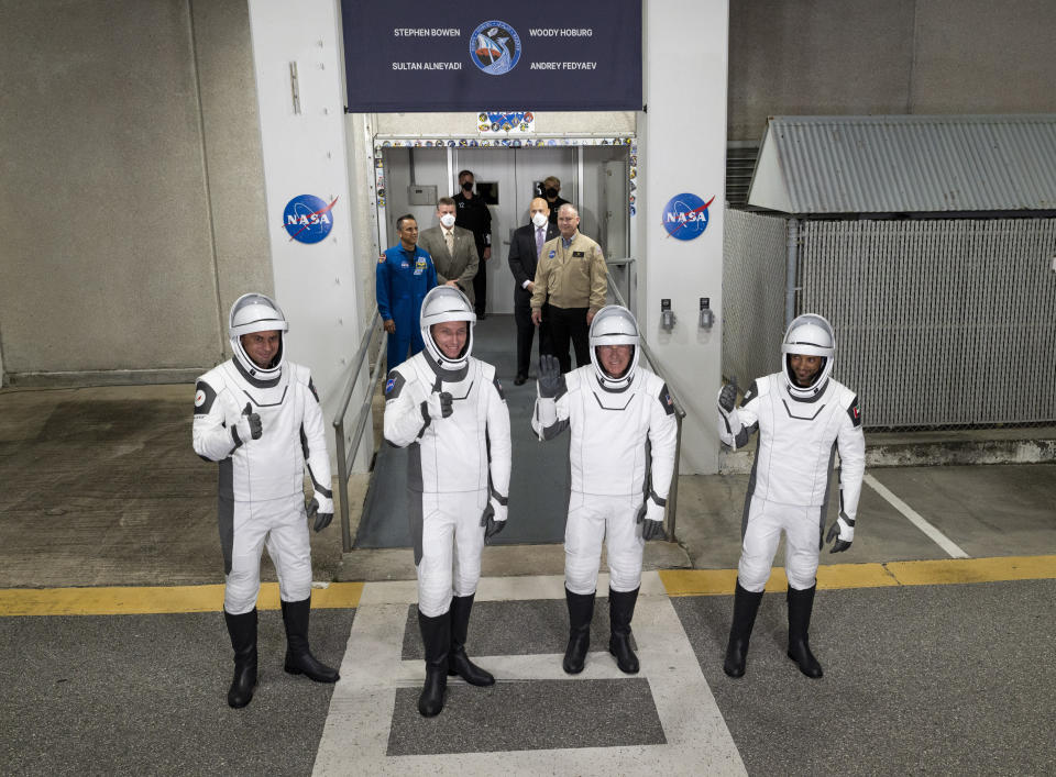 Roscosmos cosmonaut Andrey Fedyaev, left, NASA astronaut Warren "Woody" Hoburg, second from left, NASA astronaut Stephen Bowen, second from right, and United Arab Emirates astronaut Sultan Alneyadi, right, wear SpaceX spacesuits as they prepare to depart the Neil A. Armstrong Operations and Checkout Building for Launch Complex 39A to board the SpaceX Dragon spacecraft for the Crew-6 mission launch, Wednesday, March 1, 2023, at NASA's Kennedy Space Center in Cape Canaveral, Fla. (Joel Kowsky/NASA via AP)