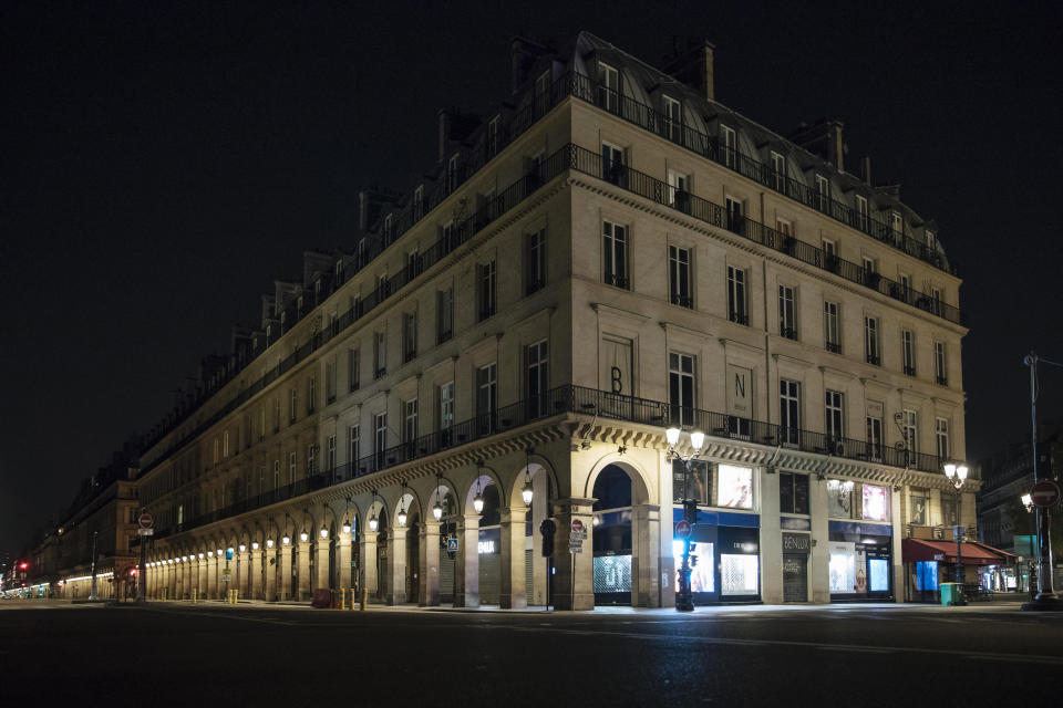 Rivoli street is empty during curfew in Paris, Saturday, Oct. 17, 2020. French restaurants, cinemas and theaters are trying to figure out how to survive a new curfew aimed at stemming the flow of record new coronavirus infections. The monthlong curfew came into effect Friday at midnight, and France is deploying 12,000 extra police to enforce it. (AP Photo/Lewis Joly)