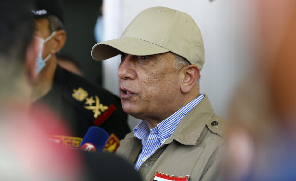 Iraqi Prime Minister Mustafa al-Kadhimi speaks to the journalists at Iraq-Iran border crossing of Mandali in northern province of Diyala, Iraq, Saturday, July, 11, 2020. Al-Kadhimi launched a campaign in the northern province of Diyala to enforce the proper payment of taxes on imported goods and recover "hundreds of millions of dollars" in revenues lost to bribery and other illicit practices. Security forces from the Interior Ministry would supervise the work of border guards in the first step of the campaign in the Mandili border crossing, he told reporters. (Thaier al-Sudani, Pool via AP)