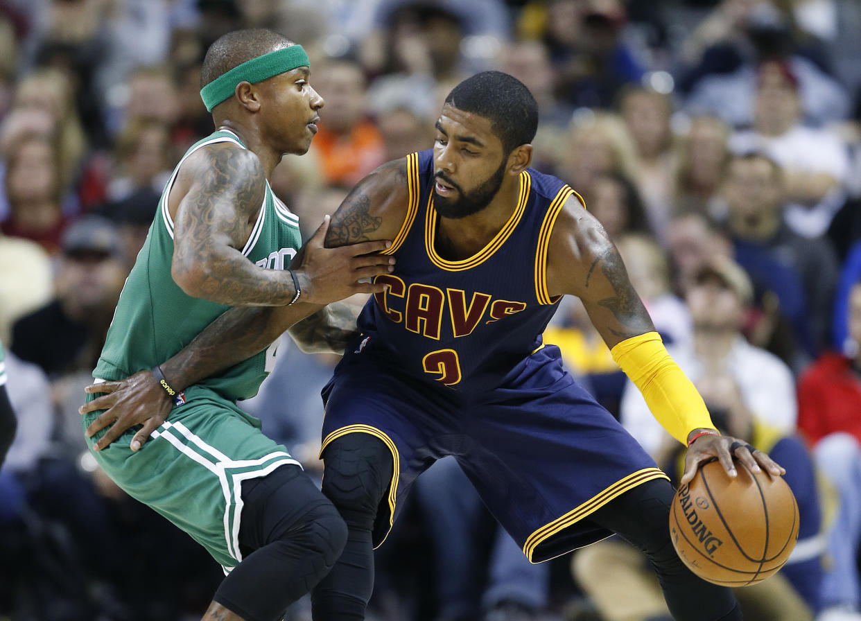 Kyrie Irving works against Isaiah Thomas during a game last November. (AP Photo/Ron Schwane)