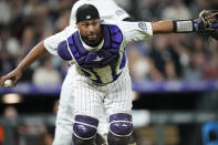 Colorado Rockies catcher Elias Diaz throws to first base to put out San Francisco Giants' Darin Ruf in the eighth inning of a baseball game, Monday, May 16, 2022, in Denver. (AP Photo/David Zalubowski)