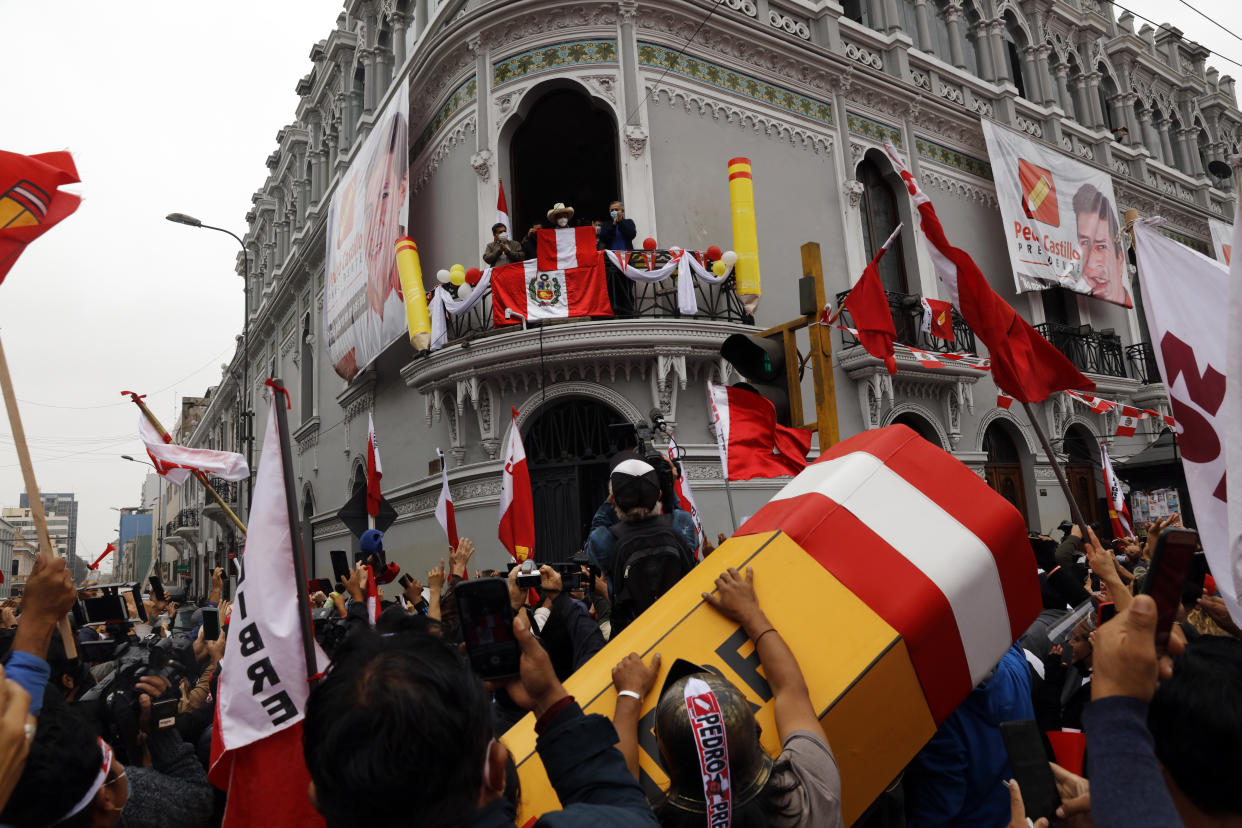 FILE - Presidential candidate Pedro Castillo looks out over supporters from the balcony of his campaign headquarters as they celebrate partial results in Lima, Peru, June 7, 2021, the day after the runoff election. On Dec 7, 2022, President Pedro Castillo dissolved the nation's Congress and called for new legislative elections as lawmakers prepared to debate a third attempt to remove him from office. (AP Photo/Guadalupe Pardo, File)