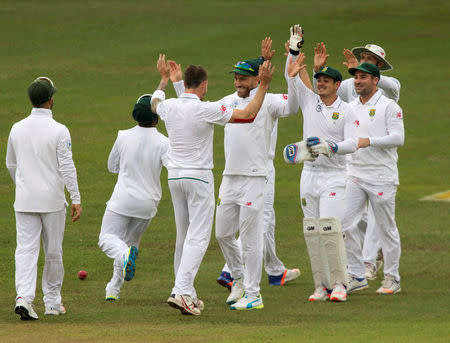 Members of South Africa celebrate the wicket of New Zealand's Tom Latham (not in picture) during the second day of the first cricket test match in Durban, South Africa, August 20, 2016. REUTERS/Rogan Ward