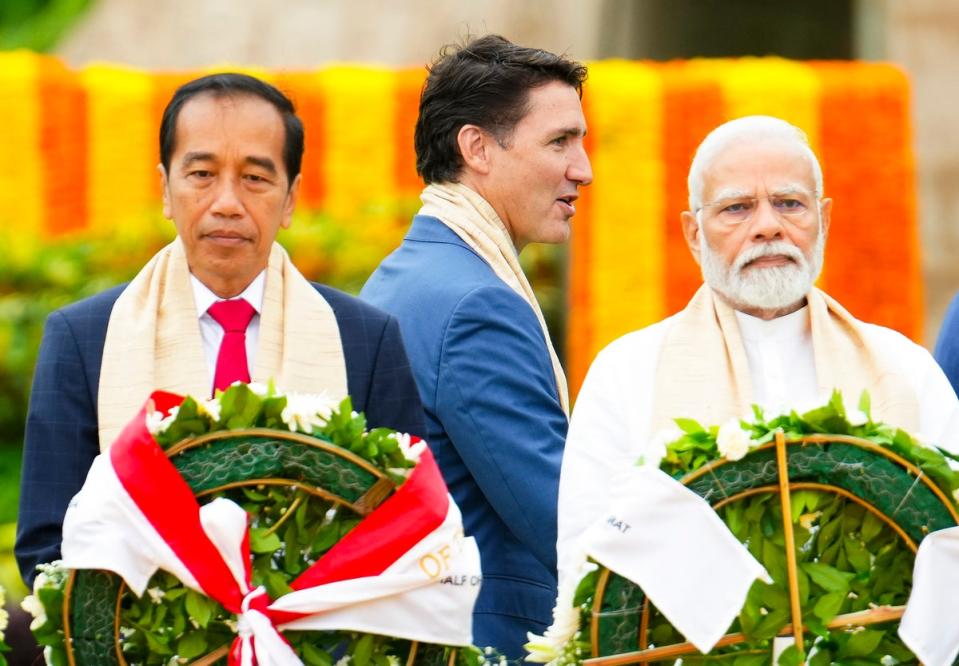 Trudeau walks past Narendra Modi and Indonesia’s president Joko Widodo as they take part in a wreath-laying ceremony at Raj Ghat (Mahatma Gandhi's cremation site) during the G20 Summit (Sean Kilpatrick/The Canadian Press via AP)