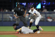 Atlanta Braves' Ozzie Albies (1) slides into second base after hitting a double as Miami Marlins shortstop Jon Berti (5) is late with the tag during the ninth inning of a baseball game, Tuesday, May 2, 2023, in Miami. The Braves defeated the Marlins 6-0. (AP Photo/Marta Lavandier)