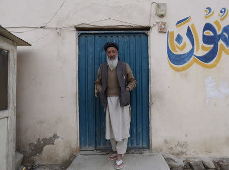 Former Guantanamo Bay detainee Mohammed Zahir poses for a photo outside his work place in Kabul, Afghanistan November 19, 2015. Picture taken November 19, 2015. REUTERS/Ismail Azami