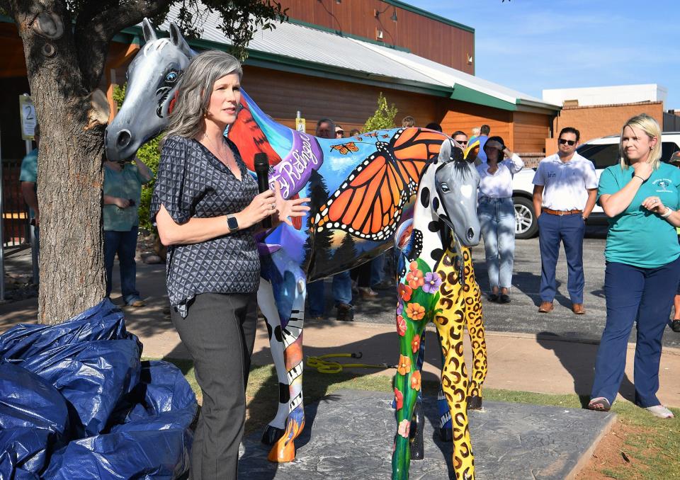 Wichita Falls artist Katie Britt talks about the design features she included while painting two Mane Event horse sculptures in memory of Christy Ridinger. The horses are in front of Texas Roadhouse.