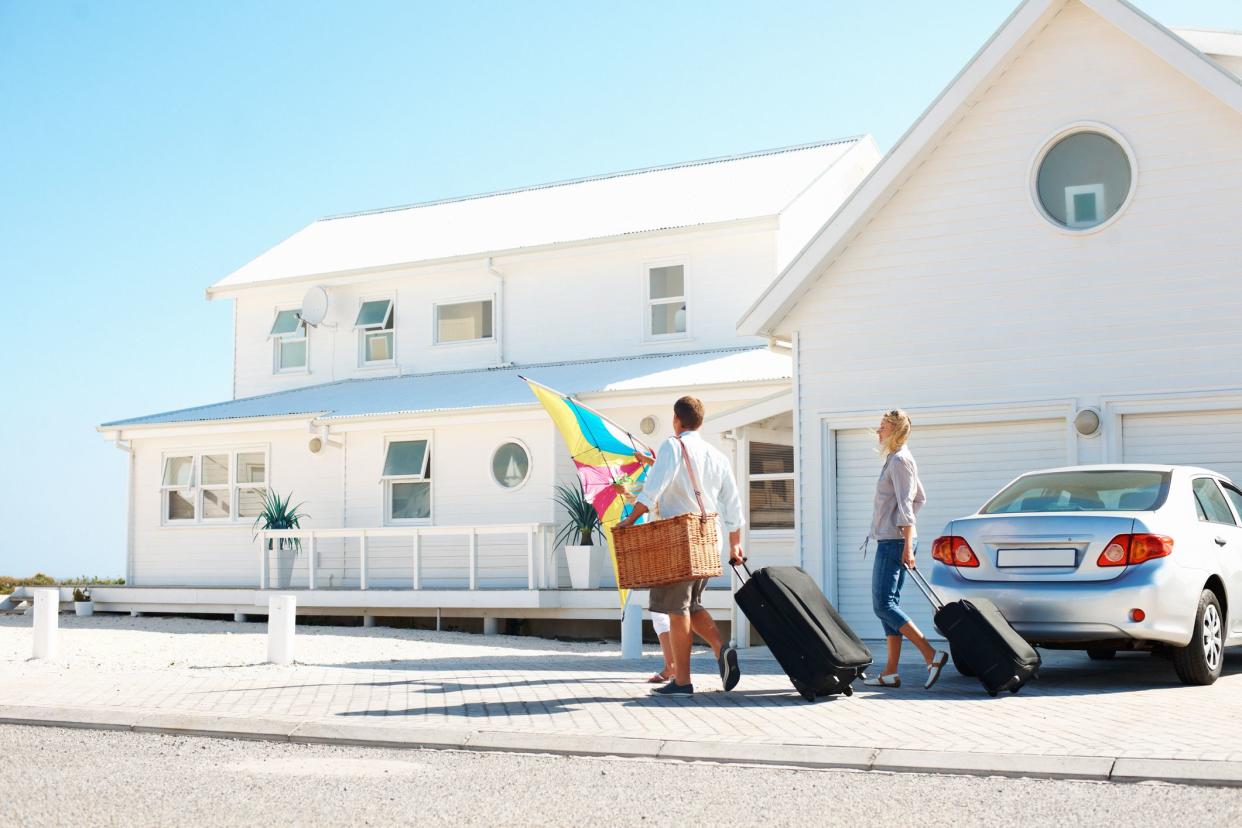 Young family arriving at their holiday beach house