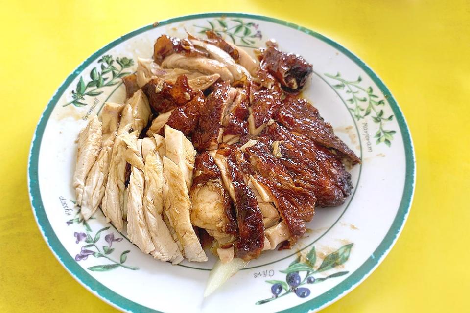 Half a roast chicken with the iconic herb design plate.