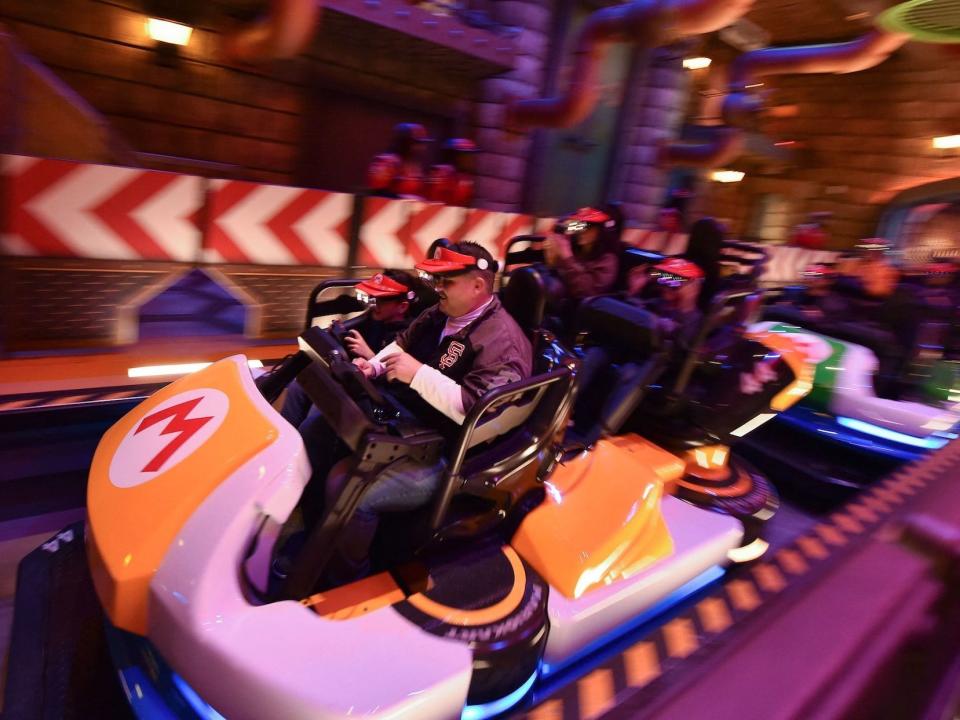 Guests ride Super Mario Kart during a preview of Super Nintendo World at Universal Studios in Los Angeles, California, on January 13, 2023. -