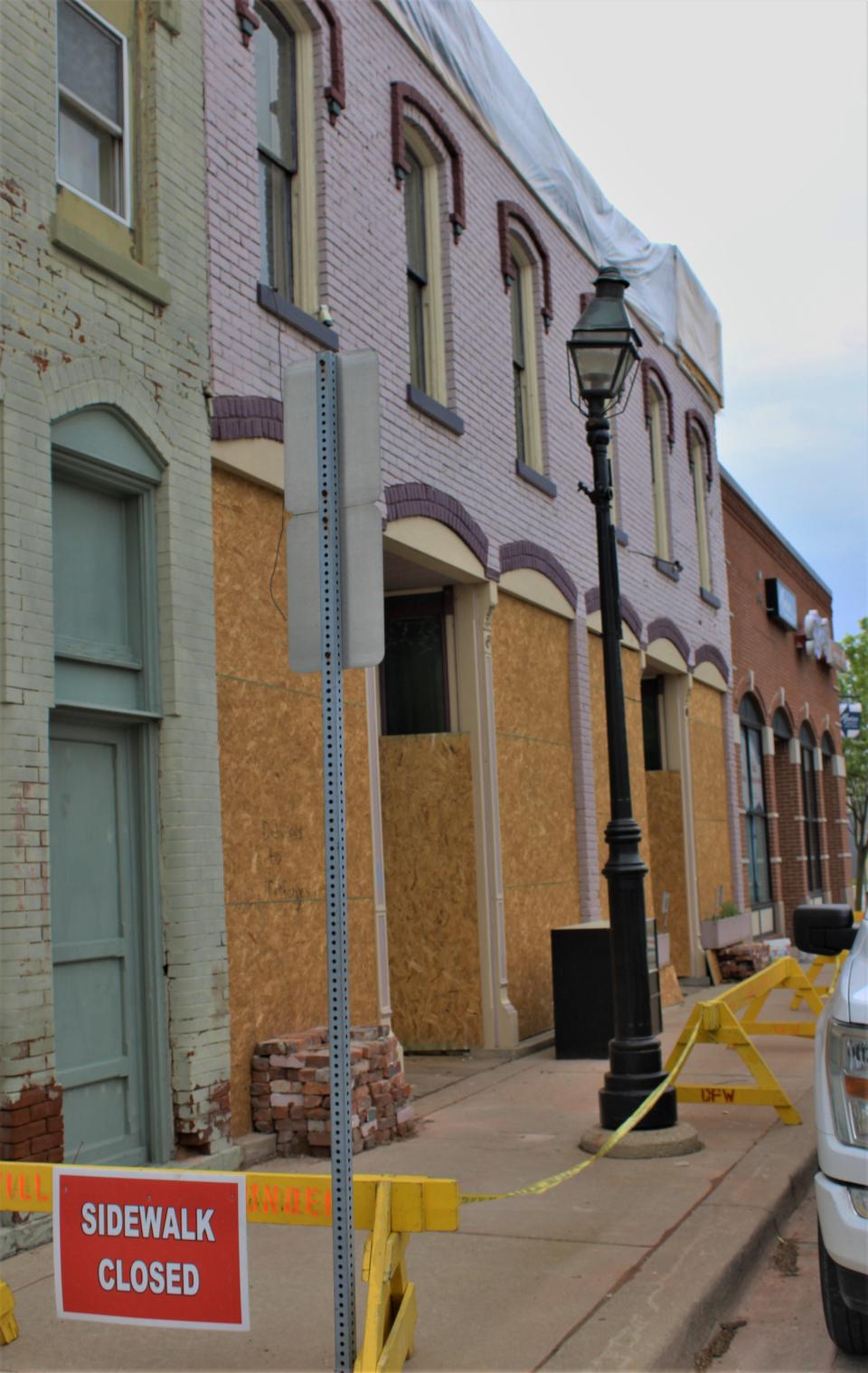 The sidewalk is closed outside of Cool Beanz Coffee on Park Place in downtown Dundee. Boarded up windows, stacks of bricks and a tarped roof show the damage remaining from a tornado April 1.