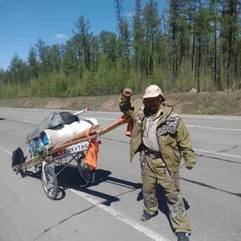 Mr Gabyshev carries a yurt and stove in his pull-cart - Credit: VK