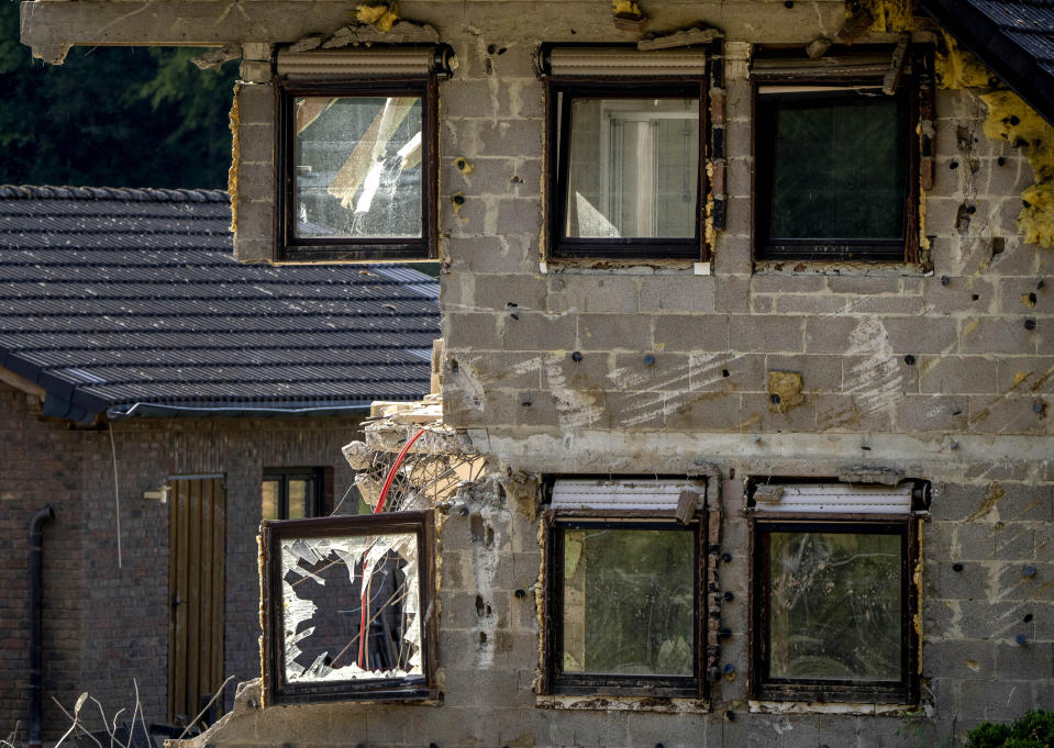 A house damaged by last year's flood still visible in the village of Ahrbrueck in the Ahrtal valley, Germany, Tuesday, July 5, 2022. Flooding caused by heavy rain hit the region on July 14, 2021, causing the death of about 130 people. (AP Photo/Michael Probst)