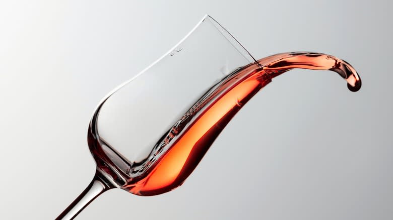 Cognac swirling out of a tilted tulip glass