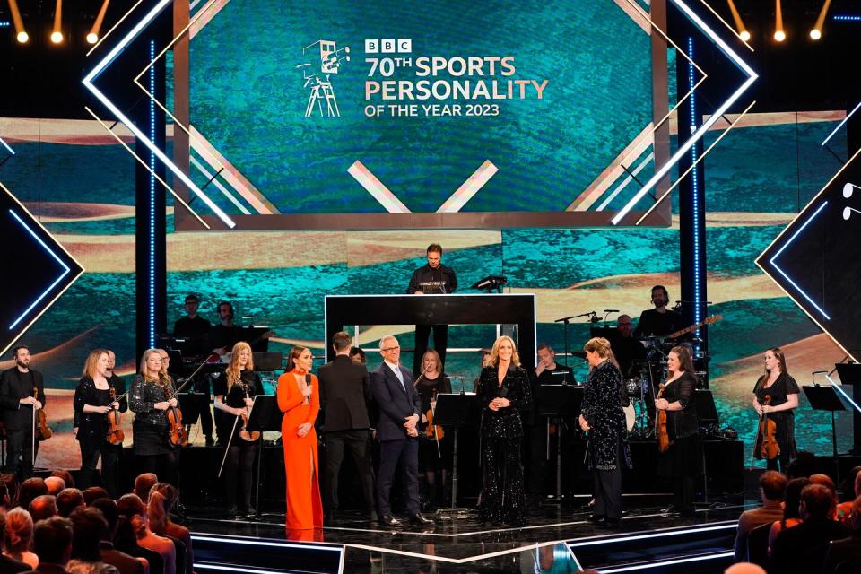 alex scott, gary lineker, pete tong, gabby logan, clare balding, and others on stage at the 70th annual bbc sports personality of the year awards in 2023