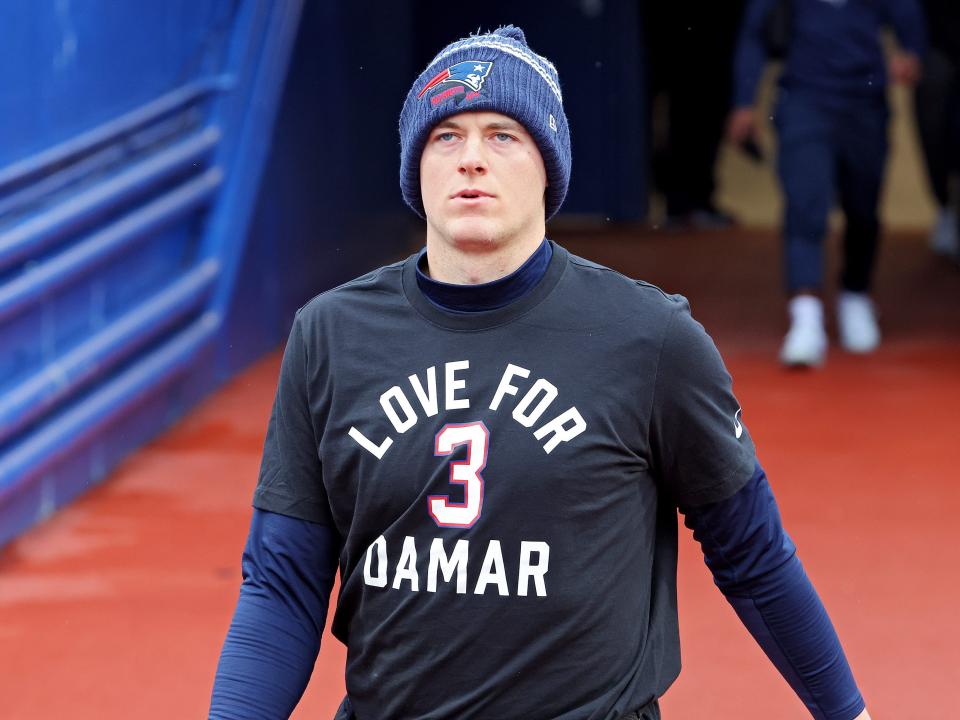 Mac Jones #10 of the New England Patriots wears "Love For Damar" shirt before game.