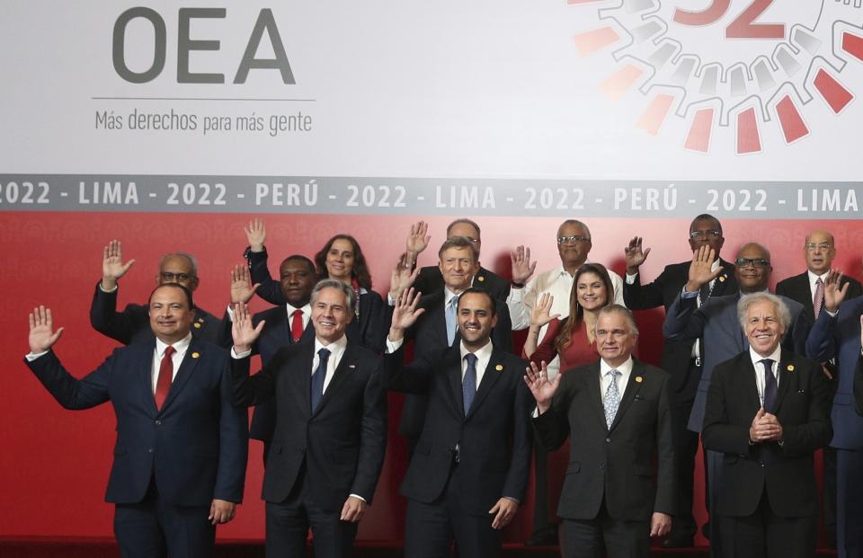 U.S. Secretary of State Antony J. Blinken, second from the left, waves as he stands with the leaders and representatives of the countries of the Organisation of American States during a group photo during the 52nd OAS General Assembly in Lima, Peru, Thursday, Oct. 6, 2022. (AP Photo/Guadalupe Pardo)