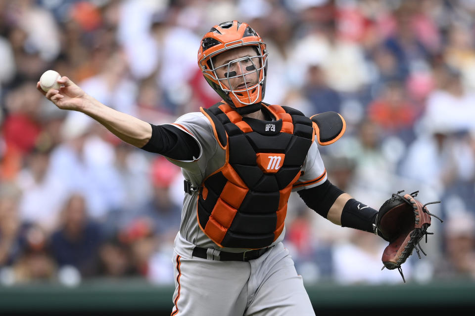 San Francisco Giants catcher Buster Posey throws to first to get out Washington Nationals' Joe Ross during the fourth inning of a baseball game, Sunday, June 13, 2021, in Washington. (AP Photo/Nick Wass)