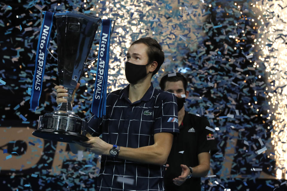 Daniil Medvedev of Russia holds up the winners trophy as confetti falls after defeating Dominic Thiem of Austria in the final of the ATP World Finals tennis match at the ATP World Finals tennis tournament at the O2 arena in London, Sunday, Nov. 22, 2020. (AP Photo/Frank Augstein)