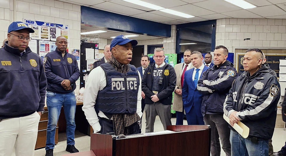 This photo provided by the Office of New York City Police Department Assistant Commissioner Kaz Daughtry, Monday, Feb. 5, 2024, shows New York Mayor Eric Adams, left center, who joined investigators and specialized teams as they carried out a search warrant. The raid, in the Bronx borough of New York, targeting suspects in a cell phone theft ring came as Adams and police officials have been promising a crackdown on crimes committed by migrants, following a brawl between migrants and police officers in Times Square. (Office of New York City Police Department Assistant Commissioner Kaz Daughtry via AP)