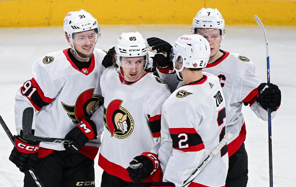 Ottawa Senators' Jake Sanderson (85) celebrates with teammates after scoring against the Montreal Canadiens during the first period of an NHL hockey game in Montreal, Tuesday, Jan. 23, 2024. (Graham Hughes/The Canadian Press via AP)