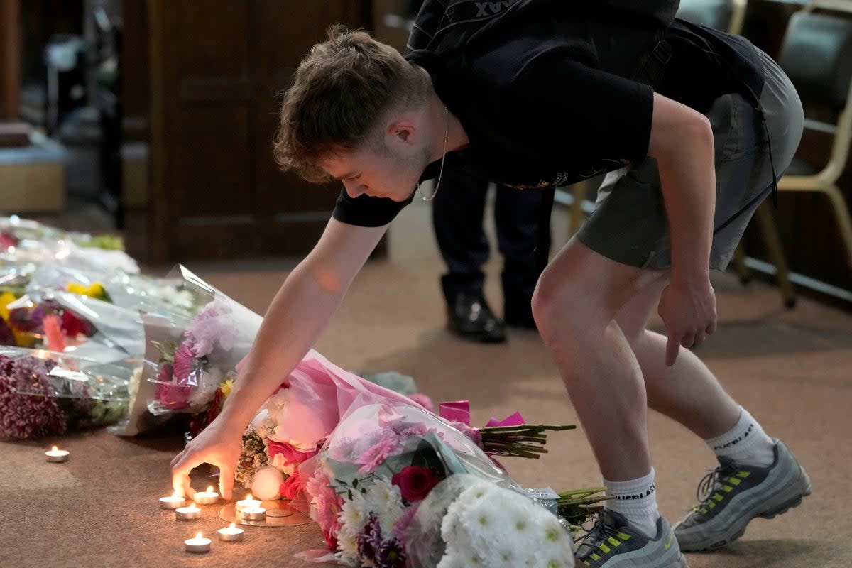 Friends of the victims brought flowers to a vigil (Getty)