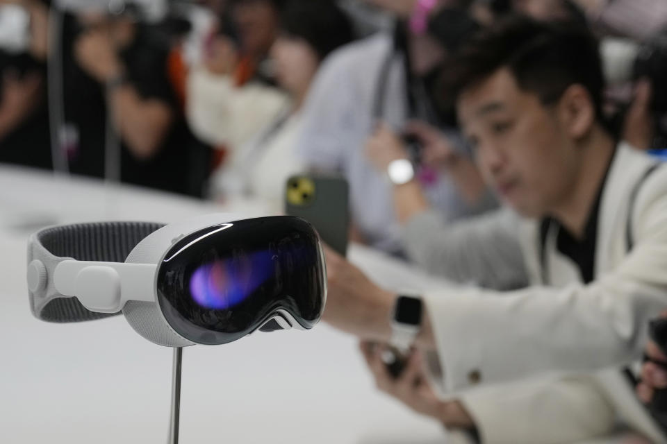 File - The Apple Vision Pro headset is displayed in a showroom on the Apple campus in Cupertino, Calif., after it's introduction at the company's annual developers conference, Monday, June 5, 2023. The Vision Pro is a high-priced headset that blends virtual reality with augmented reality that projects digital images on top of real-world settings. (AP Photo/Jeff Chiu, File)