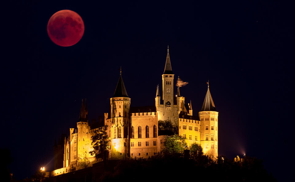 Rising behind the Hohenzollern Castle in Hechingen, Germany. (Photo: Matthias Hangst via Getty Images)