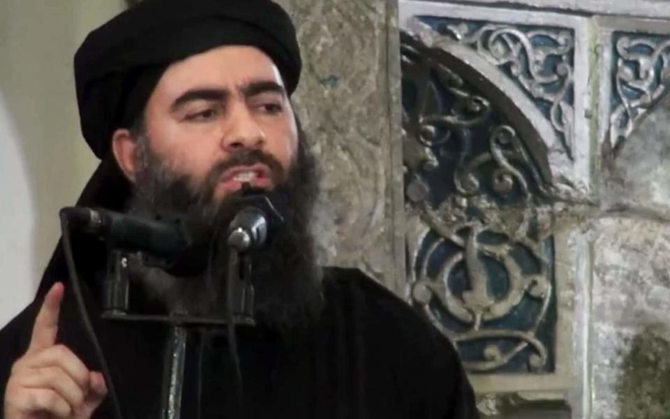 This file image made from video posted on a militant website in 2014 purports to show Abu Bakr al-Baghdadi - Credit: AP