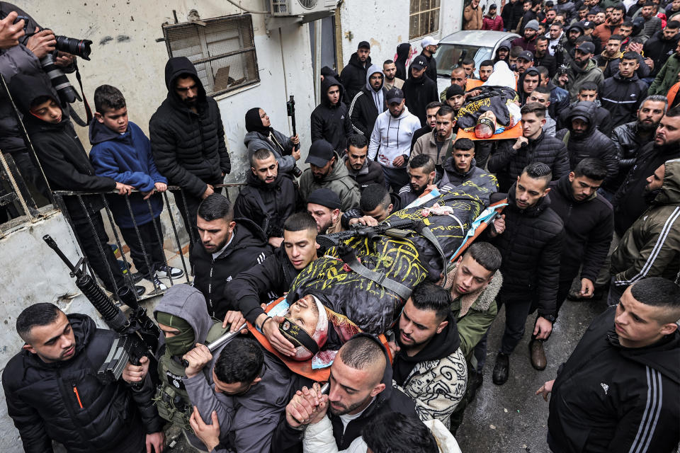 Mourners march carrying the bodies of the two Ghazawi brothers, who were among three Palestinian men killed when undercover Israeli agents raided the Ibn Sina hospital in the city of Jenin, during the funeral in the occupied West Bank city, Jan. 30, 2024. / Credit: ZAIN JAAFAR/AFP/Getty