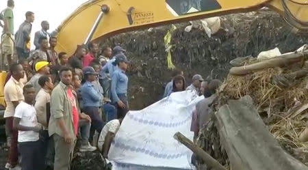 People gather at the site after a landslide at a garbage dump on the outskirts of Addis Ababa, Ethiopia in this still image taken from a video from March 12, 2017. REUTERS/Reuters TV