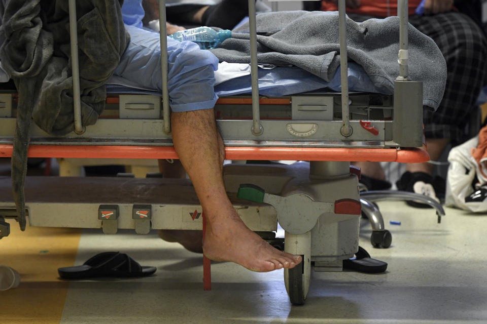 Patients lie on beds in a crowded COVID-19 isolation room at the University Emergency Hospital in Bucharest, Romania, Friday, Oct. 22, 2021. In Romania, a European Union country of around 19 million, only 35% of adults are fully inoculated against COVID-19 compared to an EU average of 74%. (AP Photo/Andreea Alexandru)