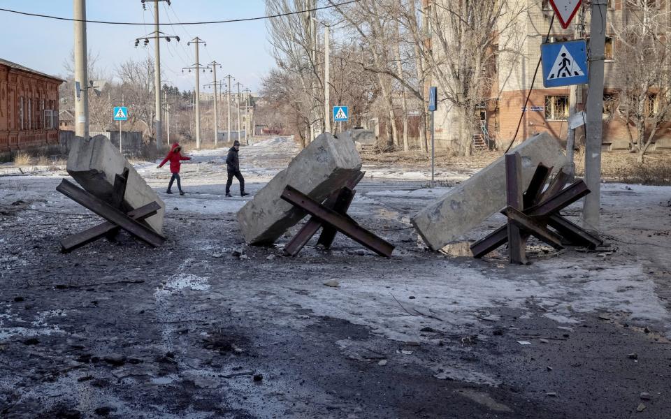 Residents on an empty street in Bakhmut - STRINGER/REUTERS