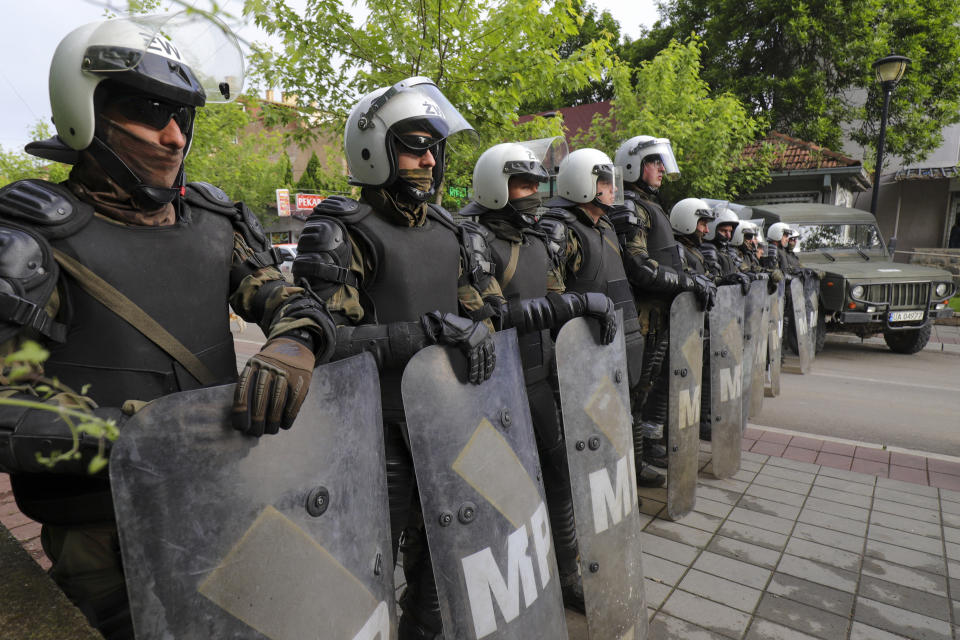 Polish soldiers, part of the peacekeeping mission in Kosovo KFOR guard a municipal building in the town of Zvecan, northern Kosovo, Monday, May 29, 2023. Ethnic Serbs in northern Kosovo on Monday tried to take over the local government buildings where Albanian mayors entered last week with the help of police. (AP Photo/Bojan Slavkovic)