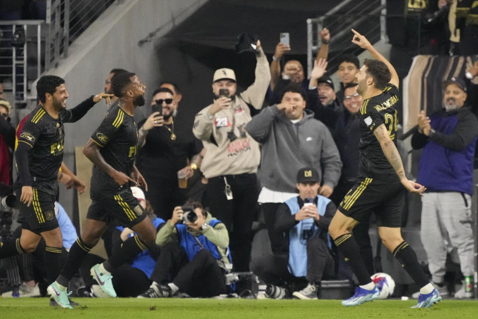 Los Angeles FC midfielder Ryan Hollingshead, right, celebrates his goal during the first half in the MLS playoff Western Conference final soccer match against Houston Dynamo, Saturday, Dec. 2, 2023, in Los Angeles. (AP Photo/Marcio Jose Sanchez)